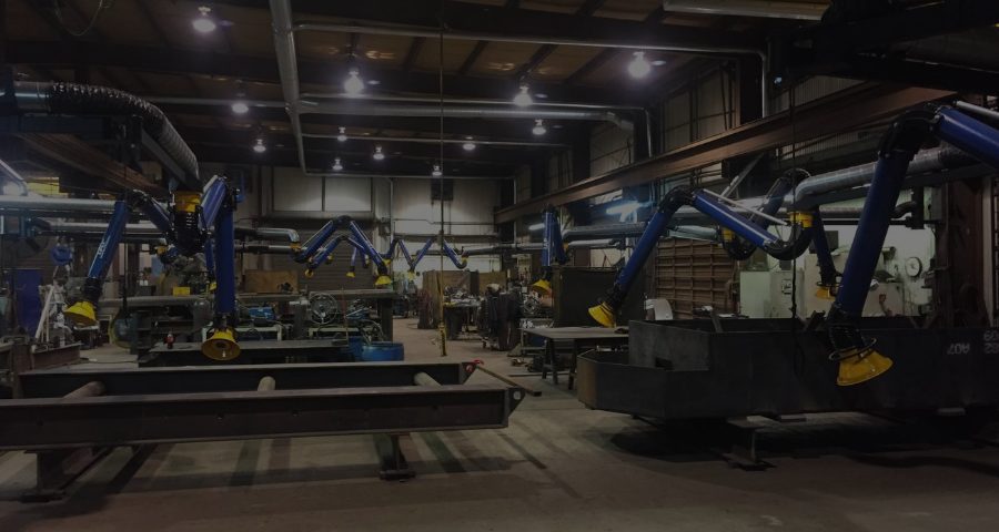IAP source capture fume extraction arms installed in a welding fabrication shop